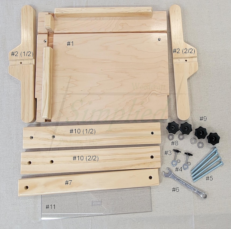May include: A wooden jig for making picture frames, with numbered parts and instructions. The jig includes a wooden base, two side pieces, two top pieces, two bottom pieces, a ruler, and a wrench. The jig is made of light wood and has a natural finish.