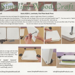 May include: A white flat plate book press with four black knobs and a book on top. The press is made of laminate and is used for pressing books flat.