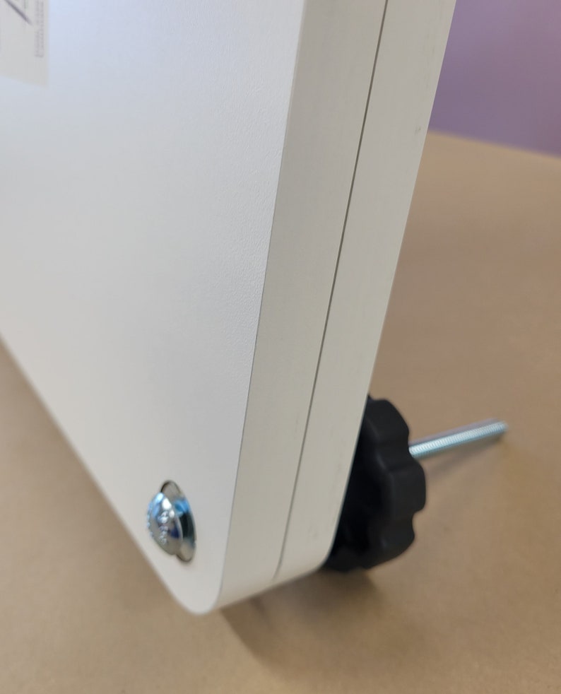 May include: White metal stand with a black knob and a silver screw. The stand has a textured surface.