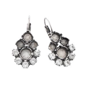 May include: A pair of silver-toned drop earrings featuring a cluster design. Each earring includes a central circular setting, smaller empty circular bezels, and several clear, faceted round stones set along the lower edge with lever-back closures.