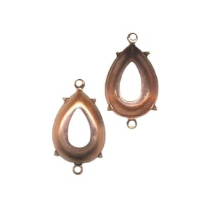May include: Two teardrop-shaped, antique copper-coloured jewellery findings. Each finding has a central teardrop-shaped opening, a loop at the top, and a loop at the bottom. Small decorative points are on the sides.