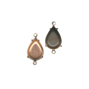 May include: Two antique bronze teardrop-shaped jewellery settings. Each setting has a small loop at the top and bottom for attaching to other components. The settings have a bezel to hold a stone or other embellishment.
