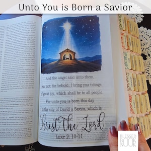 May include: An open Bible with a page featuring a nativity illustration of a stable under a bright star. The text reads, "And the angel said unto them, fear not: for behold, I bring you tidings of great joy, which shall be to all people."