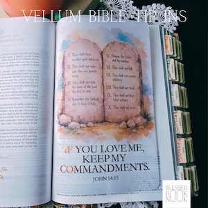 May include: A vellum bible tip-in insert featuring a watercolor illustration of the Ten Commandments on two stone tablets. Below the tablets, the text reads: IF YOU LOVE ME, KEEP MY COMMANDMENTS. JOHN 14:15. The page has decorative book tabs.