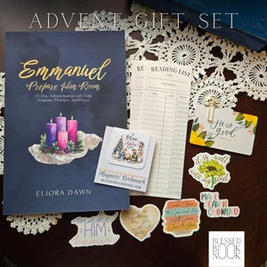 May include: An Advent gift set featuring a dark blue journal titled Emmanuel Prepare Him Room, a magnetic bookmark with a nativity scene, two reading list cards, a cross paperclip, and several die-cut stickers with floral and religious text.