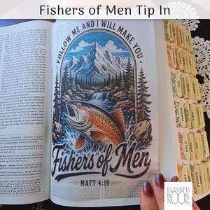 May include: A Bible page insert featuring a colorful illustration of a trout jumping from water in front of a mountain and forest landscape. The text reads Follow Me and I Will Make You, Fishers of Men, and Matt 4:19. The page has decorative tabs.