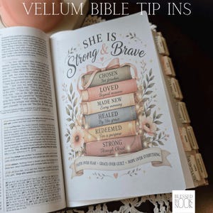May include: A vellum bible tip-in page featuring a stack of six pastel-colored books tied with a ribbon. The books are labeled with the words Chosen, Loved, Made New, Healed, Redeemed, and Strong. A banner at the bottom reads Faith Over Fear.