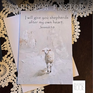 May include: A rectangular greeting card featuring an impressionistic painting of a white lamb on a textured light gray background. The text reads: I will give you shepherds after my own heart. Jeremiah 3:15. The card is paired with a plain white envelope.