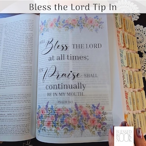 May include: A translucent Bible tip-in page featuring the text Bless the Lord at all times; His praise shall continually be in my mouth. Psalm 34:1, decorated with watercolor pink roses and blue flowers, alongside a Bible with indexed tabs.