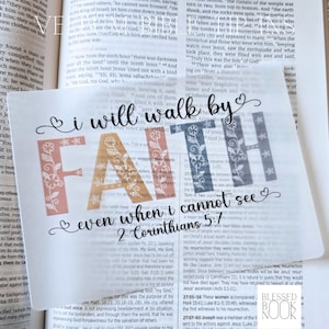 May include: A translucent rectangular bookmark featuring the black cursive text I will walk by, the word FAITH in large block letters with floral patterns in shades of peach and grey, and the text even when I cannot see 2 Corinthians 5:7.