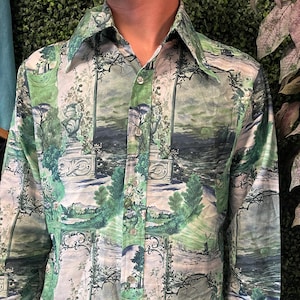 May include: A long-sleeve button-down shirt with a landscape print in shades of green, white, and gray. The shirt features a classic collar and buttoned cuffs. The landscape design includes trees, water features, and architectural elements.