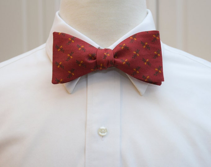Christmas red bow tie, gold berries, green pine boughs, red herringbone, holiday bowtie
