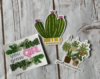 May include: Three stickers with plant-themed designs. One features a green cactus with pink flowers and the text "DON'T BE A PRICK." Another says "you grow GIRL" with green leaves. The third shows potted plants and the text "just one more."