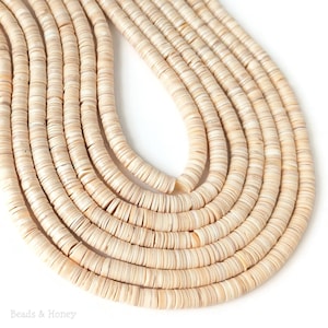 May include: Multiple strands of off-white, flat, circular disc-shaped beads arranged in a curved, layered formation. The beads have a smooth, matte texture with subtle variations in tone, and the text Beads & Honey is printed in the corner.