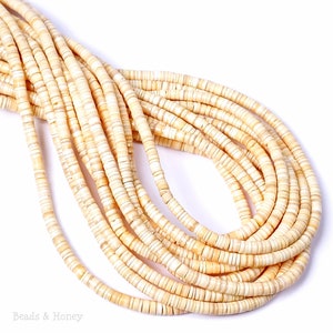 May include: A long strand of cream-colored disc-shaped beads arranged in multiple parallel rows. The beads feature subtle variations in tone and texture, creating a natural appearance. The text "Beads & Honey" is visible in the bottom left corner.