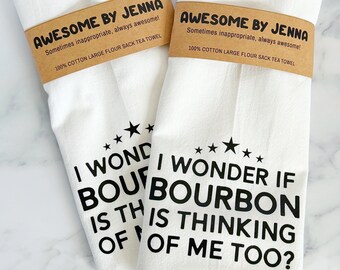 May include: Two white tea towels with black text. The text on the towels reads "Awesome by Jenna Sometimes inappropriate, always awesome! 100% Cotton Large Flour Sack Tea Towel" and "I wonder if bourbon is thinking of me too?"