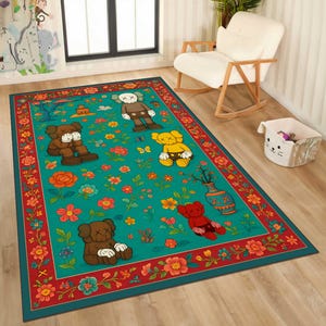 May include: A rectangular area rug with a teal background featuring cartoon figures, flowers, and butterflies. The rug has a red border with floral patterns. The cartoon figures are in various colors, including brown, yellow, and red.