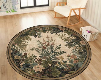 May include: A round area rug with a floral design. The rug features a cream-colored center with a detailed pattern of green and pink leaves and flowers. A dark border frames the design.