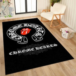 May include: Black rectangular rug featuring a white and red design. The design includes the words "ONE HEARTS" in a curved banner, a red tongue logo, and the words "CHROME HEARTS" in a decorative font.