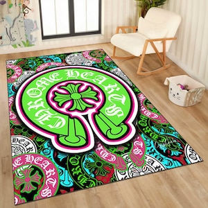 May include: A rectangular area rug with a vibrant, repeating pattern. The rug features a large, neon green horseshoe shape with the words "ONE HEARTED" in white. The background is a mix of black, teal, and pink designs.
