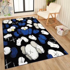 May include: Black area rug featuring a repeating pattern of cartoon-style figures, hands, and crossbones in white, blue, and gray. The rug has a rectangular shape and is placed on a wooden floor.