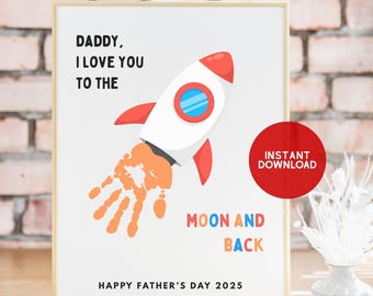 May include: A framed print with a white background features a rocket ship illustration with red and white accents. The rocket's exhaust is a handprint. Text reads "Daddy, I love you to the moon and back. Happy Father's Day 2025."