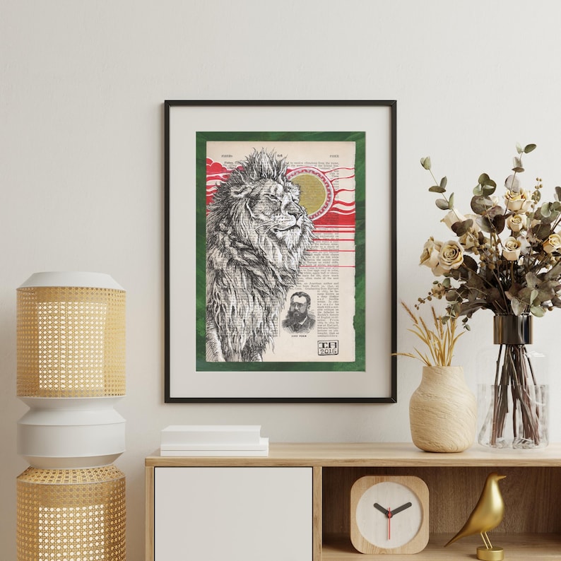 May include: A black and white illustration of a lion's head with a red and gold background. The lion is looking to the right and has a thick mane. The background is a page from an old book with text and a green border.