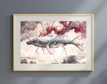 May include: Watercolor painting of a whale floating in the sky, attached to strings. The whale is gray and white with pink fins. The background features clouds and red, cloud-like shapes. The artwork is framed in a light wood frame.