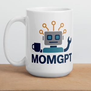 May include: White ceramic mug featuring a robot design with a wrench and a coffee cup. The robot is grey, blue, and gold, with the navy blue text "MOMGPT". The mug is on a wooden surface.