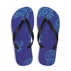 May include: A pair of blue flip-flops with black straps. The flip-flops feature a repeating pattern of sea creatures in a light blue color, including turtles, crabs, and jellyfish. The background has a binary code design.