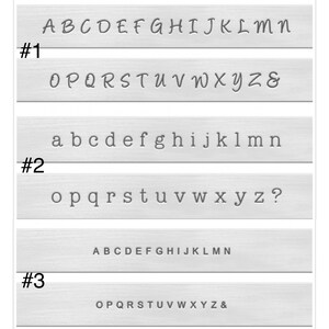 May include: Three metal plates with different fonts and letter styles. The first plate has the letters A through Z in a cursive font. The second plate has the letters a through z in a sans-serif font. The third plate has the letters A through Z in a sans-serif font.
