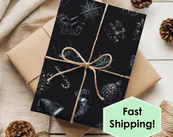 May include: A wrapped gift with black wrapping paper featuring a pattern of Christmas ornaments, a sleigh, and a skull. The gift is tied with twine and a bow. The words "Fast Shipping!" are in a green hexagon.