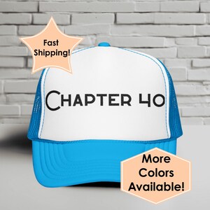 May include: A blue and white trucker hat with the text "CHAPTER 40" in black. The hat has a blue brim and mesh backing. Additional text on the image says "More Colors Available!"