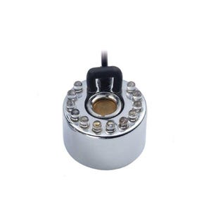 May include: A chrome-finished ultrasonic mist maker with a ring of small, clear LED lights. The device has a central gold-colored disc and a black handle for power connection. It is designed for creating mist effects.