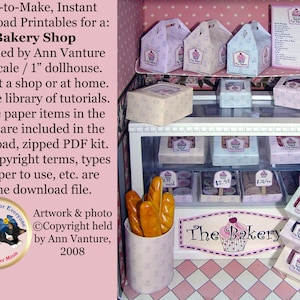 May include: A miniature bakery shop with a white display case and shelves filled with paper boxes and pastries. The sign above the case reads "The Bakery" with a pink cupcake graphic. The shop is decorated with pink and white polka dots.
