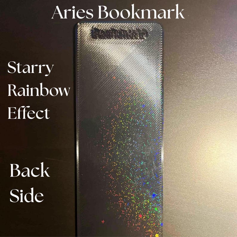 May include: A rectangular bookmark with a starry rainbow effect. The text "Aries Bookmark" is at the top, and "Starry Rainbow Effect" and "Back Side" are on the left side. The bookmark has a textured surface.