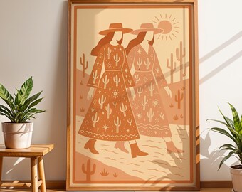 May include: A framed art print depicting two figures in long dresses and hats, set in a desert scene. The artwork uses warm orange and beige hues, with cactus and sun designs. The print is displayed on a wall, next to a small wooden table with a potted plant.