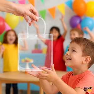 May include: A clear plastic gift bag with a handle is being handed to a young child. The bag is rectangular and has a snap closure. The background includes colorful balloons, party decorations, and other children.