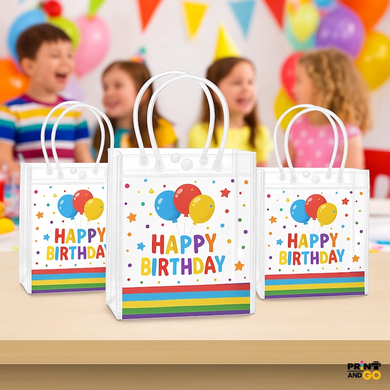 May include: Three white gift bags with white handles, each featuring a colorful "Happy Birthday" design. The design includes balloons, stars, and a rainbow stripe at the bottom. Children are in the background.