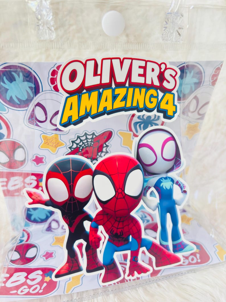 May include: A clear plastic bag containing stickers featuring Spider-Man characters. The stickers include Miles Morales, Spider-Man, Spider-Gwen, and a blue Spider-Man figure. The bag has the text "Oliver's Amazing 4" in red and yellow.