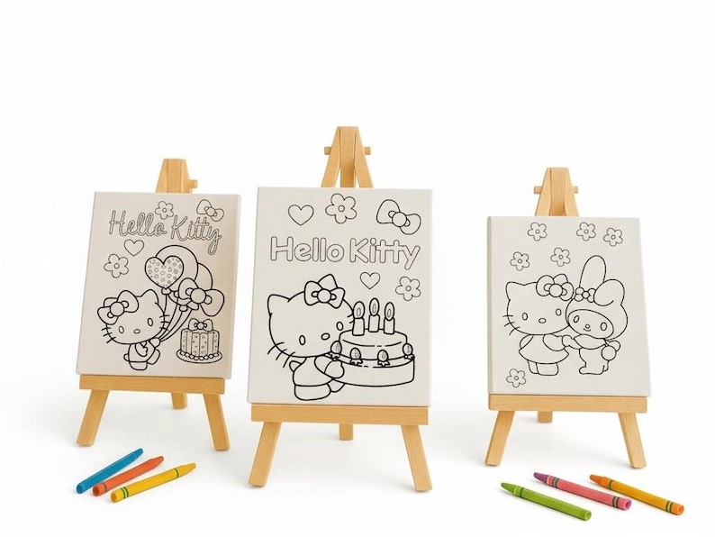 May include: Three small wooden easels each hold a canvas featuring a Hello Kitty design. The canvases are black and white line drawings of Hello Kitty with balloons, a cake, and flowers. Crayons in blue, orange, yellow, green, and red are at the bottom.