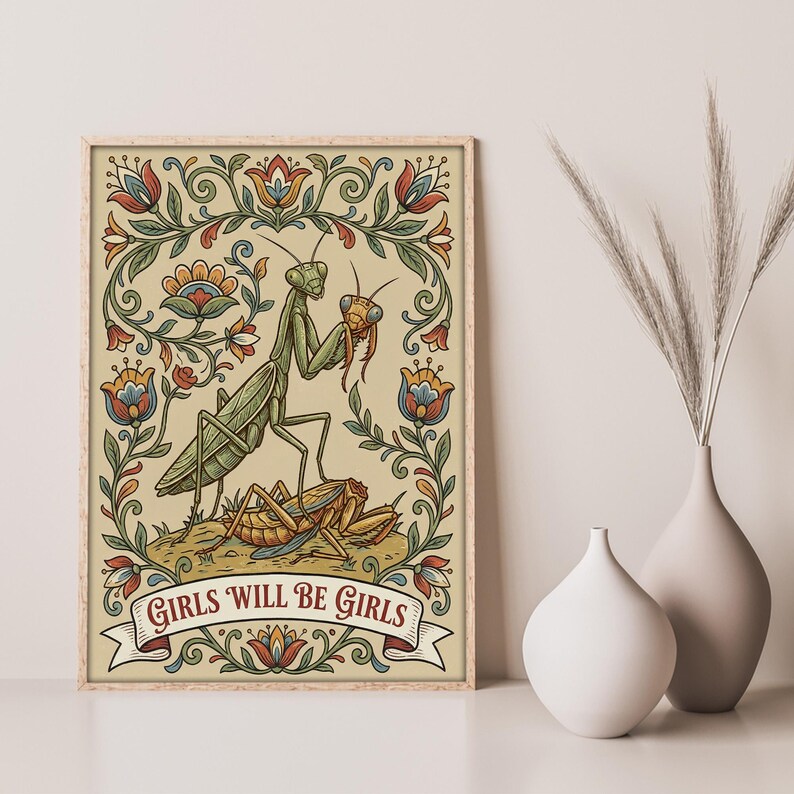 May include: A framed art print featuring a green praying mantis with a smaller insect, surrounded by floral designs in red, blue, and yellow. The banner at the bottom reads "GIRLS WILL BE GIRLS".