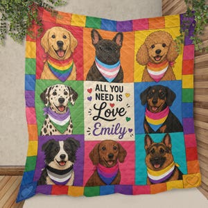 May include: A colorful quilt featuring images of various dog breeds, each wearing a bandana with pride flag colors. The quilt has a rainbow border and includes the text "ALL YOU NEED IS Love Emily".