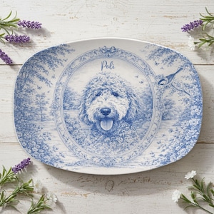 May include: Oval serving platter with a blue and white toile design. The center features a portrait of a dog with the name "Poli" above it. The border has a landscape scene with a bird.