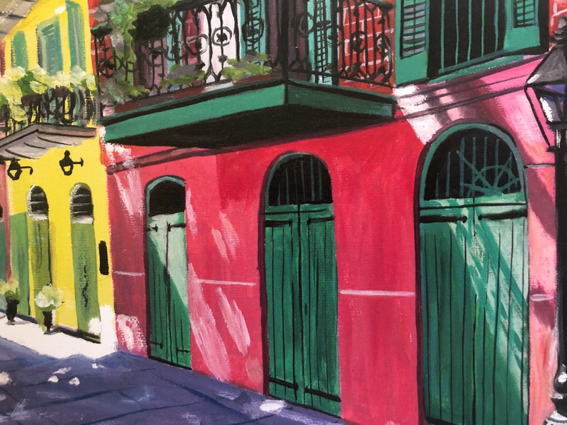 May include: A painting of a row of colorful buildings with green doors and windows. The buildings are painted in shades of yellow, red, and green. The doors are arched and have a traditional design. The windows are small and rectangular. The painting is done in a realistic style.