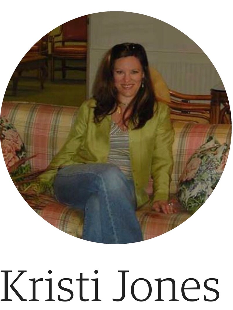 May include: A woman with long brown hair is sitting on a patterned couch. She is wearing a green jacket, a striped shirt, and blue jeans.
