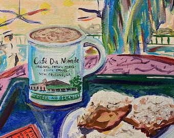 May include: A painting of a still life featuring a cup of coffee with the words "Cafe Du Monde" on the side, two beignets on a white plate, and two fairground tickets. The background is a green and blue abstract design.