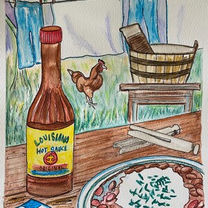 May include: Watercolour painting depicting a rural scene with a bottle of Louisiana Hot Sauce, a plate of red beans and rice, and a chicken. The painting includes a clothesline with laundry and a wooden washtub.