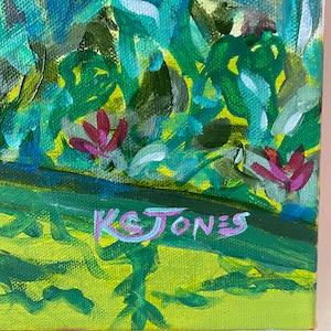 May include: A painting of a green and blue landscape with pink flowers and the artist's signature "K& JONES" in the bottom right corner.