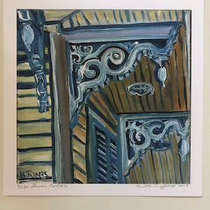 May include: A close-up of a blue and brown painting of a building's ornate wooden corbels. The painting is signed "Ruth C. Jones 2019" and numbered "2/250 True Corbels".